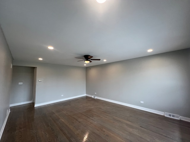 spare room with dark hardwood / wood-style floors and ceiling fan