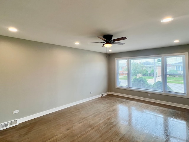 empty room featuring ceiling fan and dark hardwood / wood-style flooring