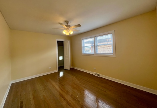 unfurnished bedroom with hardwood / wood-style floors, ceiling fan, and a closet