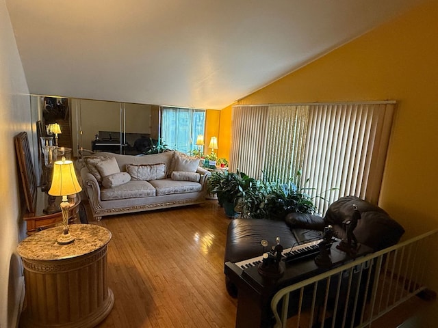 living room featuring hardwood / wood-style flooring and vaulted ceiling