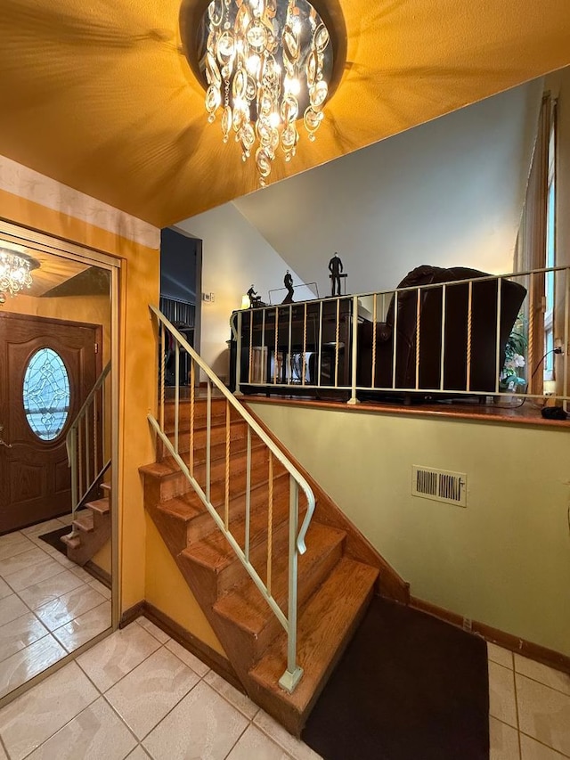 stairs featuring tile patterned floors, lofted ceiling, and a chandelier