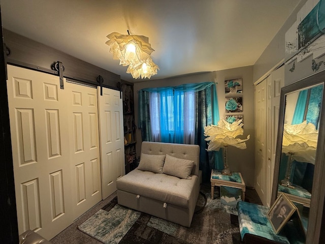 sitting room featuring carpet flooring and a barn door