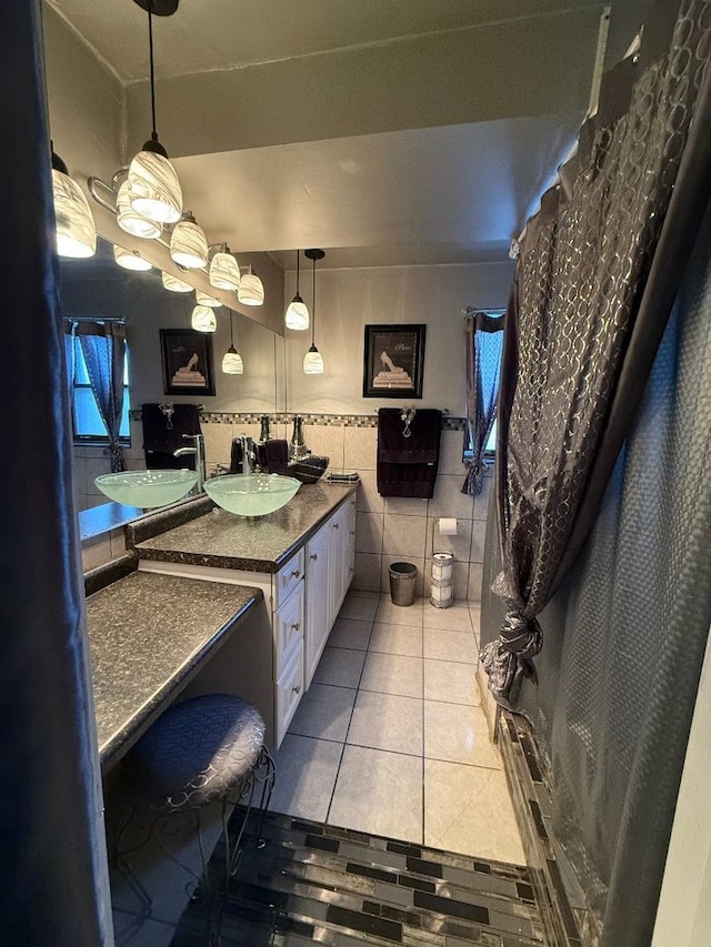 bathroom featuring tile patterned flooring, vanity, and tile walls