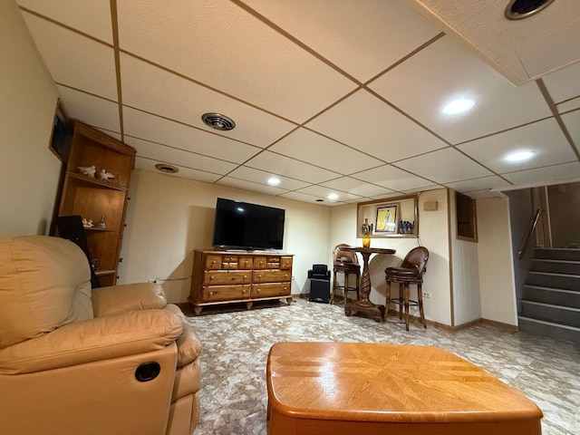 living room featuring a paneled ceiling