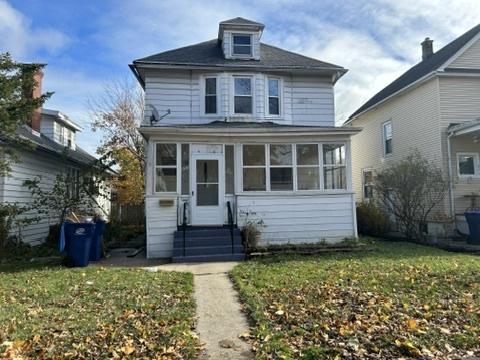 833 Hickory St, Waukegan, IL 60085 - traditional style home with a sunroom, a front lawn, and entry steps