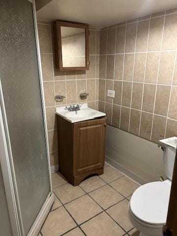 833 Hickory St, Waukegan, IL 60085 - bathroom with vanity, a shower stall, tile patterned floors, and tile walls