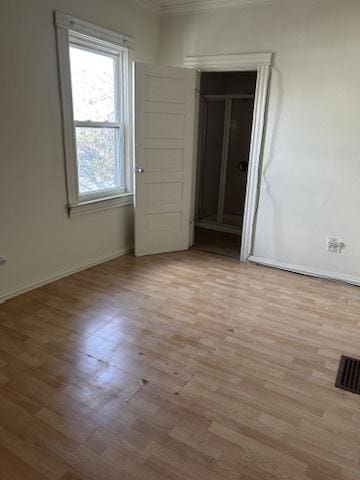 833 Hickory St, Waukegan, IL 60085 - spare room featuring ornamental molding and wood finished floors