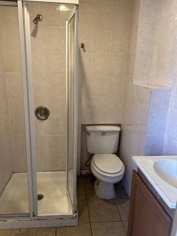 833 Hickory St, Waukegan, IL 60085 - bathroom featuring tile patterned floors, a shower stall, vanity, and tile walls
