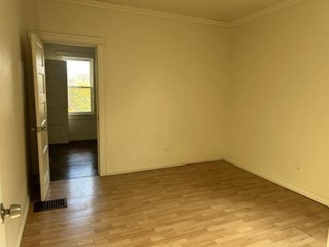 833 Hickory St, Waukegan, IL 60085 - spare room with wood finished floors and crown molding