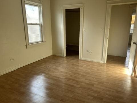 833 Hickory St, Waukegan, IL 60085 - unfurnished bedroom with multiple windows and wood finished floors