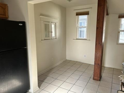 833 Hickory St, Waukegan, IL 60085 - unfurnished dining area with light tile patterned floors