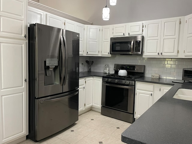 kitchen with stainless steel appliances, white cabinetry, and tasteful backsplash