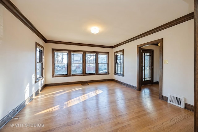 unfurnished room with light hardwood / wood-style flooring and crown molding