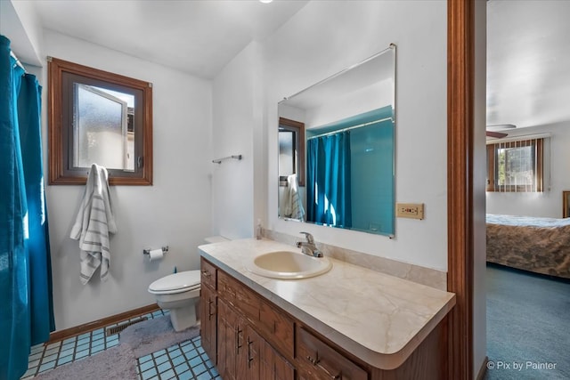 bathroom featuring vanity, ceiling fan, toilet, and curtained shower