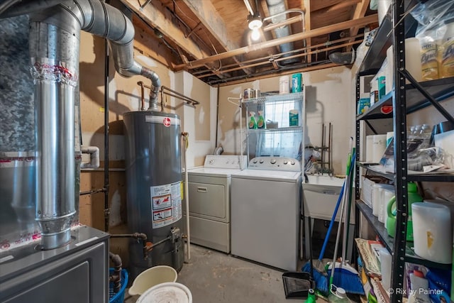 laundry room featuring water heater and independent washer and dryer