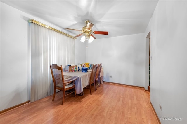 dining space featuring light wood-type flooring and ceiling fan