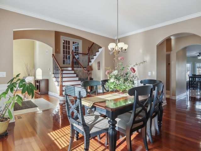 dining space featuring crown molding, hardwood / wood-style floors, and ceiling fan with notable chandelier