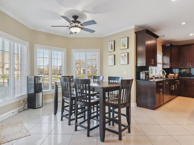 dining room with light tile patterned floors, ceiling fan, and crown molding