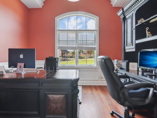 home office featuring hardwood / wood-style floors and a healthy amount of sunlight