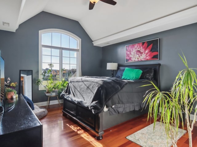 bedroom featuring ceiling fan, dark hardwood / wood-style flooring, and vaulted ceiling