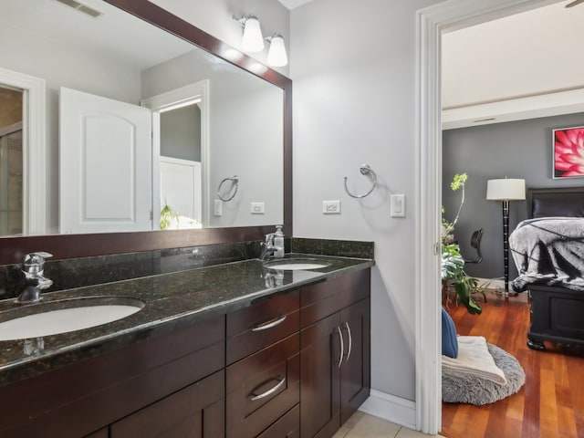 bathroom with hardwood / wood-style floors and vanity