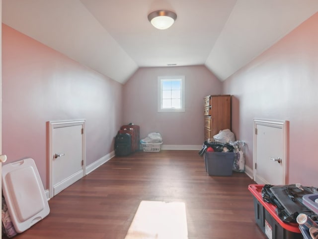 additional living space with dark hardwood / wood-style floors and vaulted ceiling