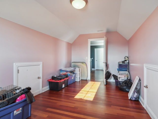 bedroom with dark hardwood / wood-style floors and lofted ceiling