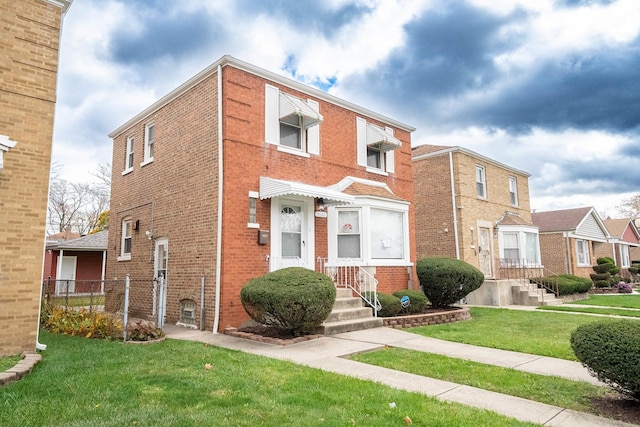 townhome / multi-family property featuring a front lawn