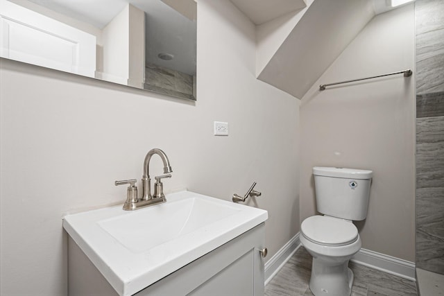 bathroom with hardwood / wood-style flooring, vanity, and toilet