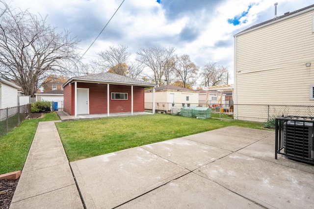 back of property with a lawn, a patio area, and central AC