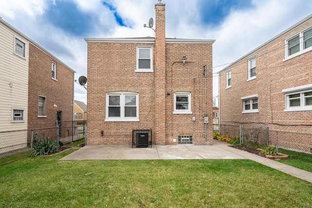 rear view of property with a yard, a patio, and central air condition unit