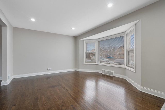 unfurnished room featuring dark wood-type flooring