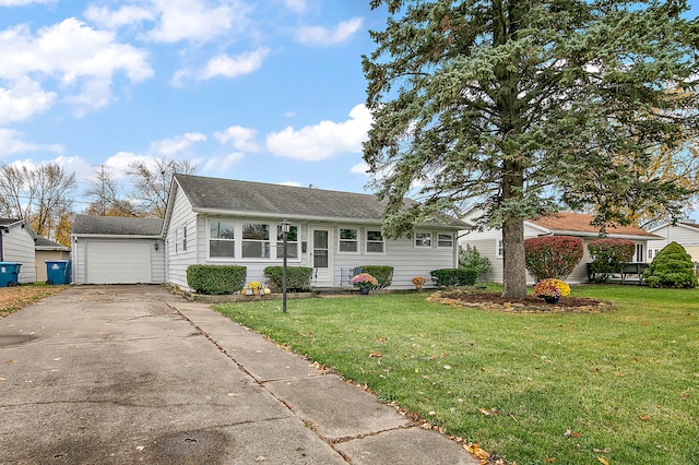 single story home featuring a garage, an outbuilding, and a front yard