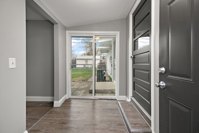 foyer featuring dark hardwood / wood-style flooring and vaulted ceiling