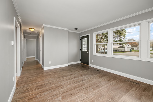 unfurnished room with hardwood / wood-style flooring and ornamental molding