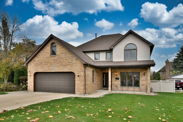 view of front of house with a garage, a front yard, and covered porch