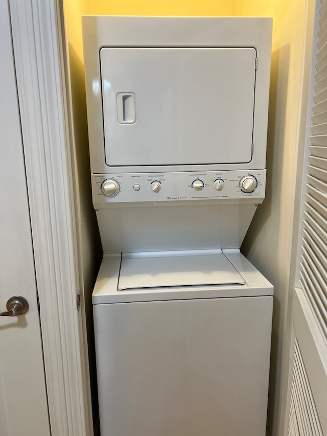 washroom featuring stacked washer and dryer