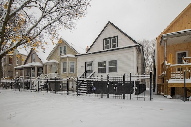 view of snow covered rear of property