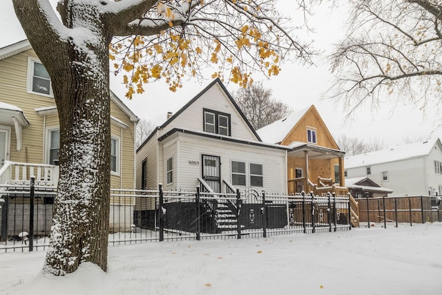 view of snow covered back of property