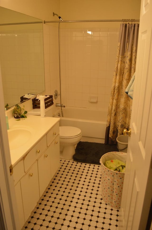 full bathroom with vanity, shower / bath combo with shower curtain, and toilet