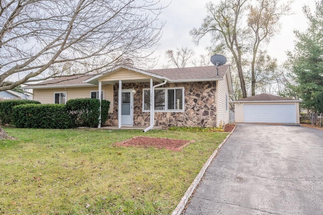 view of front of house featuring a front yard, an outbuilding, and a garage