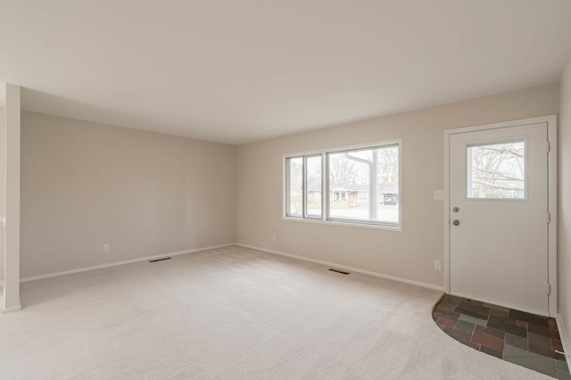 view of carpeted foyer entrance