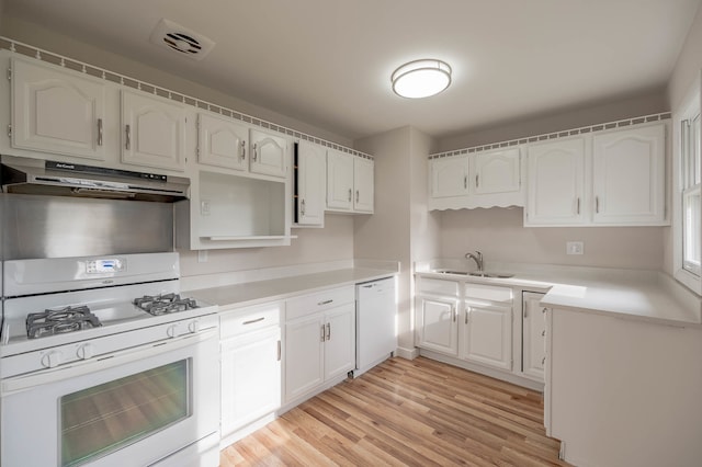 kitchen with white cabinetry, sink, white appliances, and light wood-type flooring