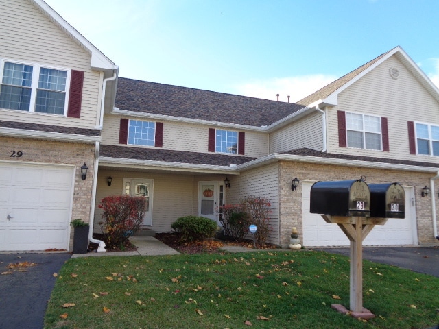 view of front of property with a garage and a front lawn