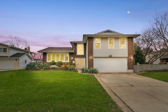 tri-level home with a lawn and a garage