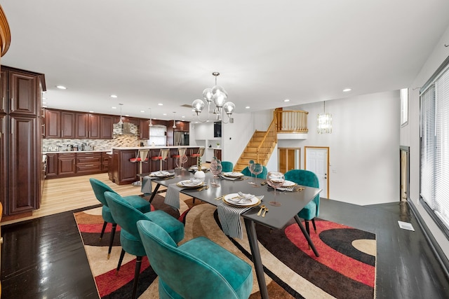 dining area featuring light hardwood / wood-style floors and a chandelier