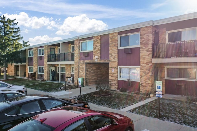 view of building exterior with a wall mounted air conditioner