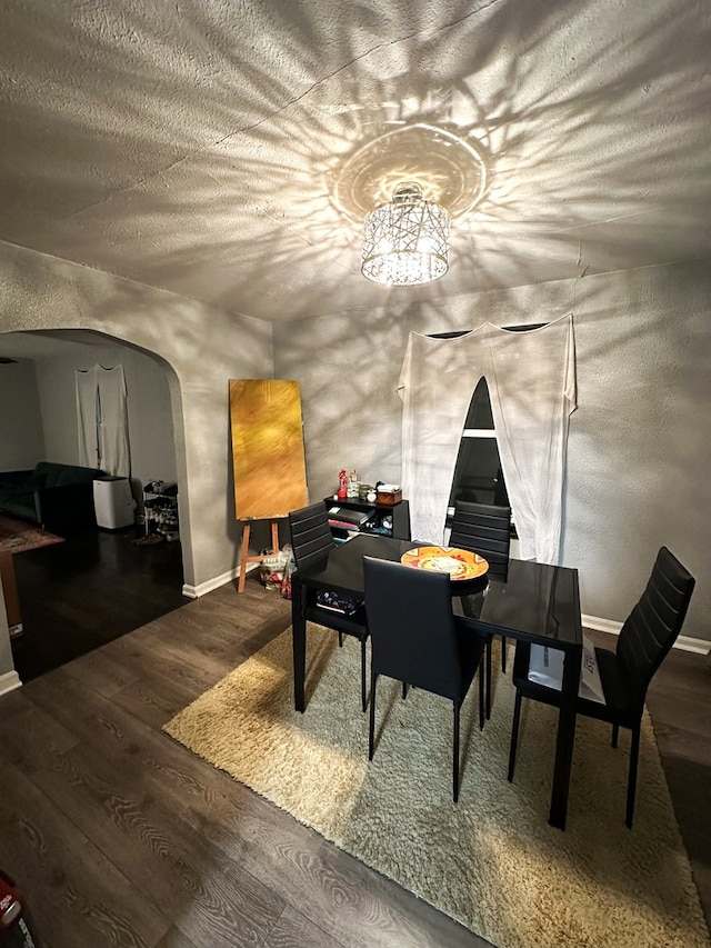 interior space featuring dark hardwood / wood-style floors, a textured ceiling, and vaulted ceiling