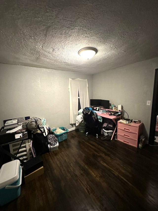 home office featuring dark hardwood / wood-style flooring and a textured ceiling