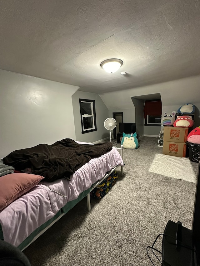 carpeted bedroom with lofted ceiling and a textured ceiling